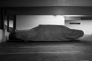 A tarp-covered car in the bowels of the Pierson-Sage parking garage. Photo by Jennifer Lu.