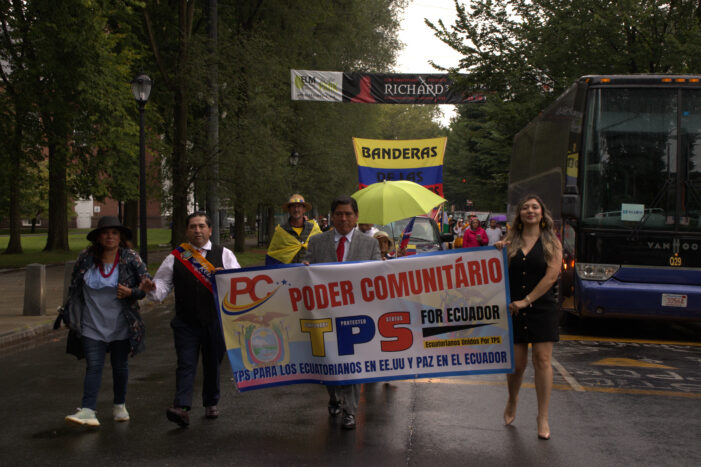 Angélica Idrovo (right) and Carlos Córdova (middle) lead the Ecuadorian parade on the New Haven Green.